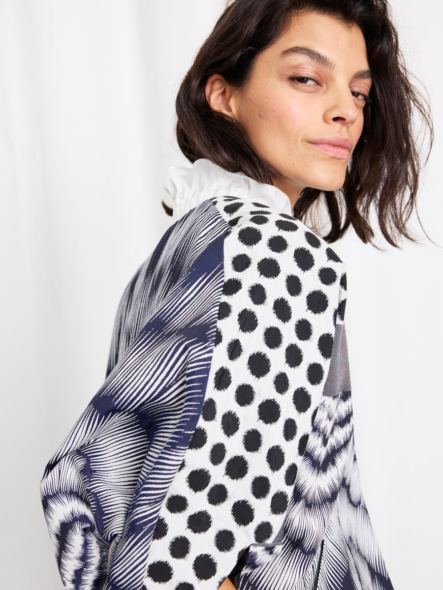 A person with shoulder-length dark hair confidently looks over their shoulder while wearing the Zero + Maria Cornejo 