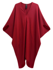 The Koya Dress by Zero + Maria Cornejo is a deep red, loose-fitting V-neck dress featuring wide sleeves and a minimalist cocoon silhouette, shown against a white background.