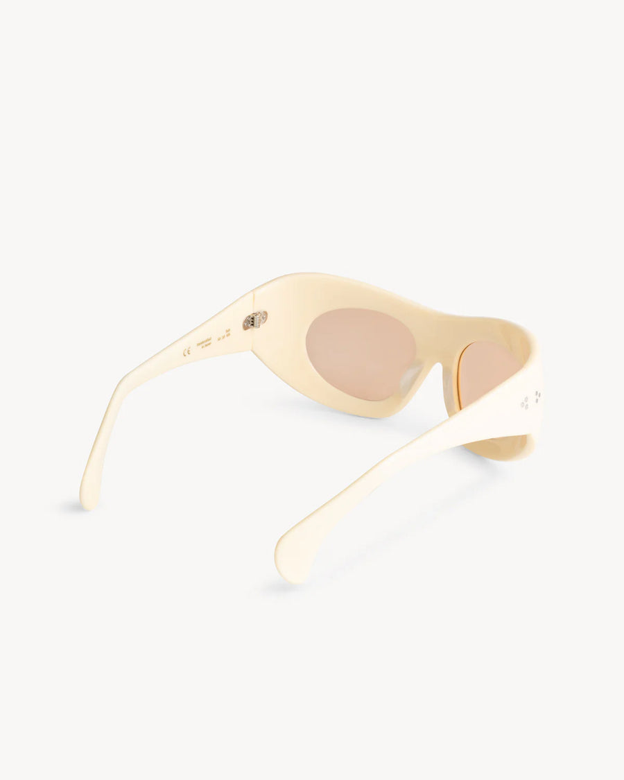 The Port Tanger Ruh by Port Tanger: cream-colored sunglasses with oval lenses and an oversized mask frame, shown from the back and side to reveal the curved arms and interior against a plain white background.