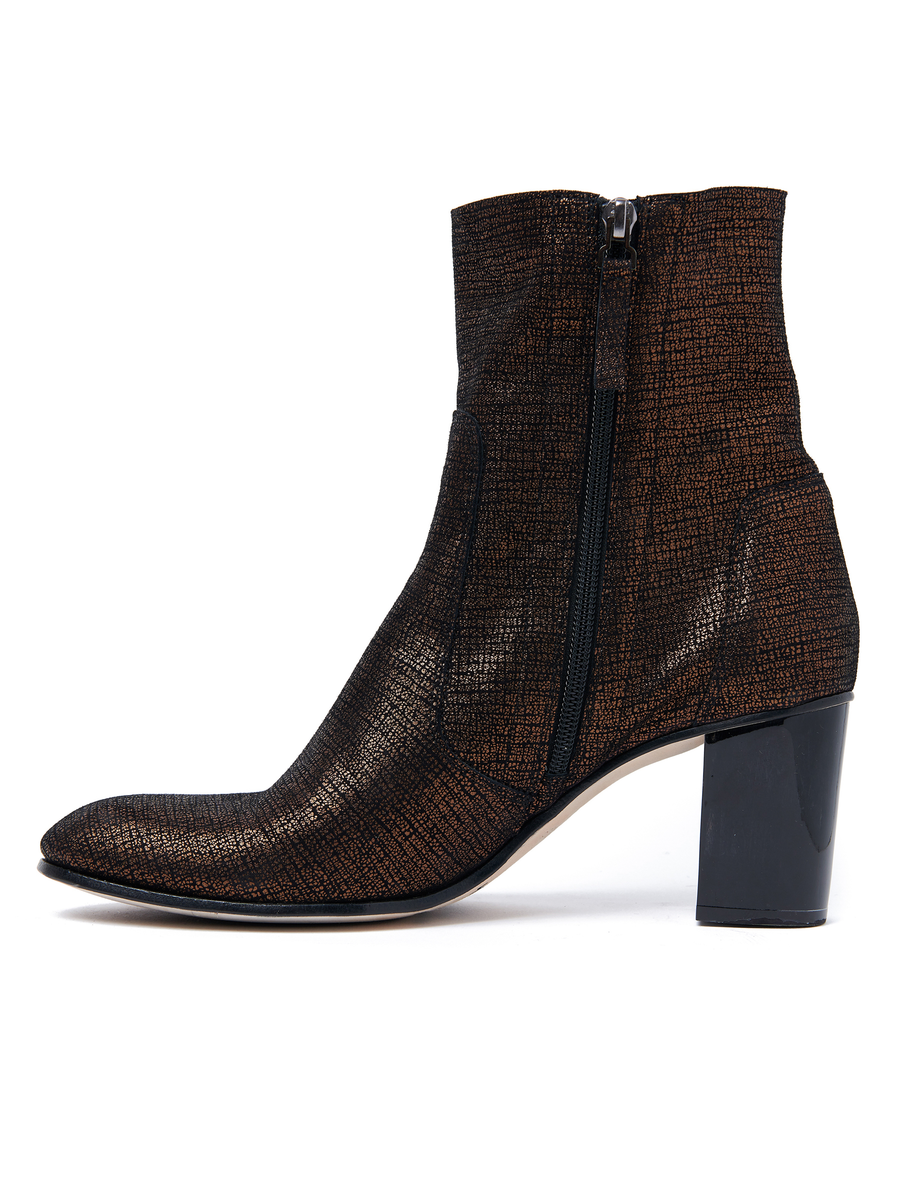 The Flo Boot by Zero + Maria Cornejo, a high-heeled ankle boot made in Italy, features textured black and bronze metallic leather, a square toe, a chunky black heel, and a side zipper for easy fastening.